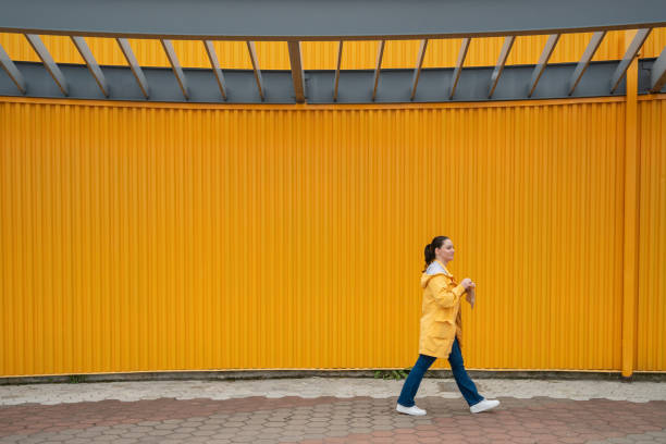 istock Latin woman outdoors wearing a yellow rain coat 1490518857