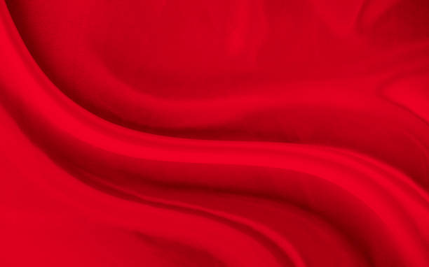 istock Black red satin dark fabric texture luxurious shiny that is abstract silk cloth background with patterns soft waves blur beautiful. 1490523602