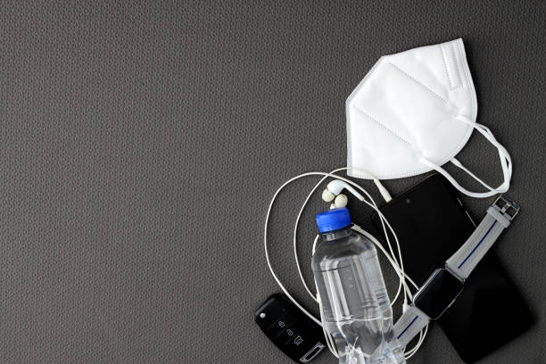 istock Fit objects to exercise in the gym prepared and protected such as a cell phone, watch, headphones and face masks to avoid contagion 1490526908
