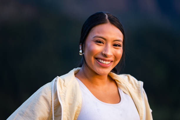 Finding Her Peace A hispanic woman stands in the Columbia River Gorge Scenic area of Oregon, at Sunset. Medium head/shoulders portraits shot with a 135mm lens to create telephoto compression. Shot in Oregon, Pacific Northwest. aborigine woman stock pictures, royalty-free photos & images