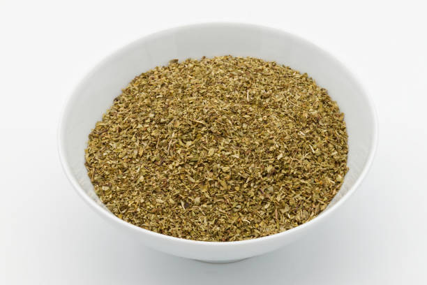 istock A bowl of dried oregano isolated on white background. 1490527793