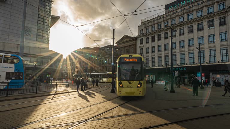 Time lapse of Moving Tram and Bus with Crowded Commuter People and Tourist walking and traveling around Manchester Downtown District