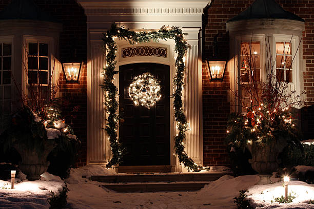 Front door with Christmas decorations An affluent home with a nice display of decorations. christmas lights house stock pictures, royalty-free photos & images