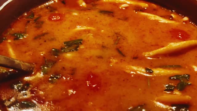 Hot spicy seafood soup, featuring succulent pieces of shrimp, tender squid, and a host of aromatic veggies and seasonings