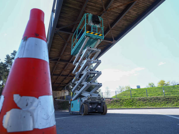 istock hydraulic scissor lift worker cleaning footbridge 1490534818