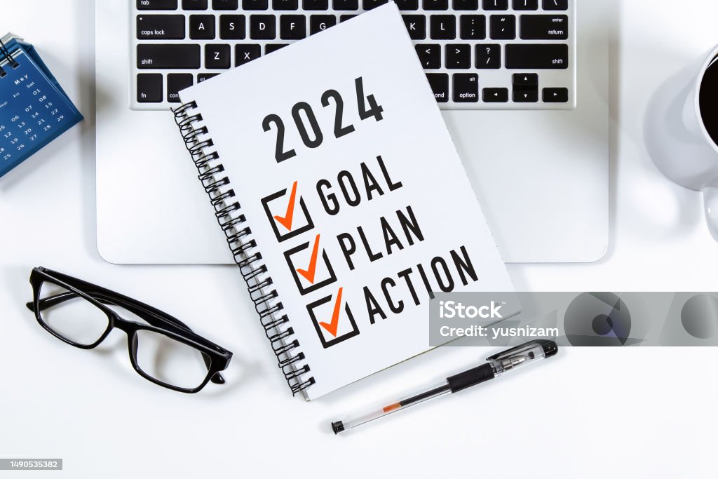 2024 Goal, Plan, Action checklist text on note pad with laptop, glasses and pen. 2024 Stock Photo