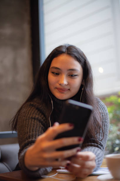 istock Young girl is talking with someone on her mobile phone. 1490539021