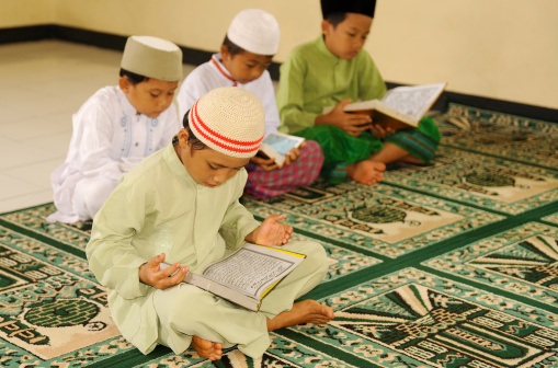 Muslim kids reciting holy Koran