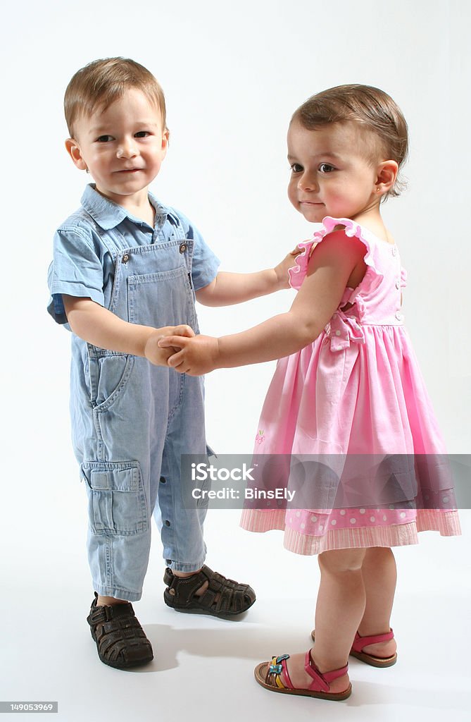 Twins dancing Adorable two years old twins dancing on a white background. Beautiful People Stock Photo