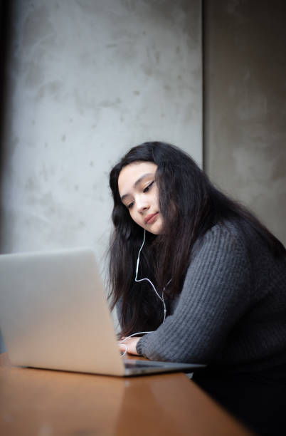 istock Female high school student is studying in coffee shop. 1490541997