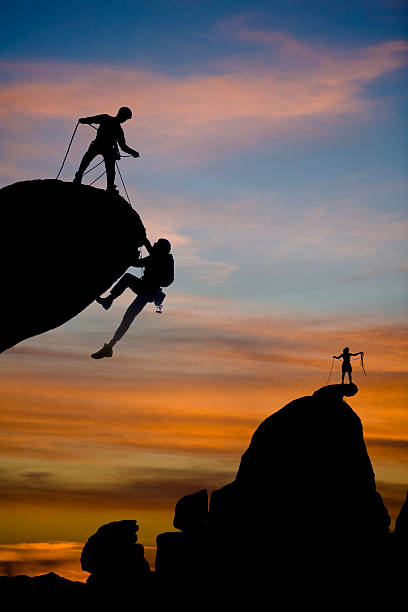 Team of climbers reaching the summit.