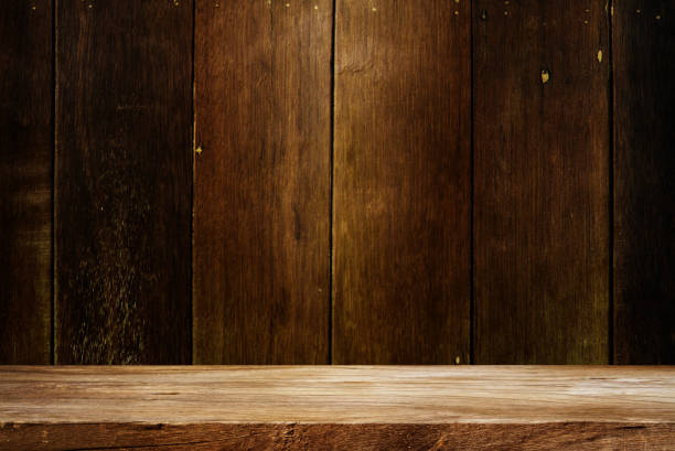 istock Wooden table in dark room 1490544525