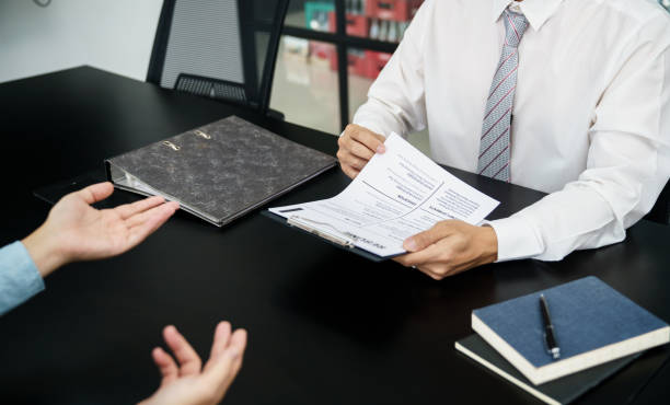 istock Examiner reading a resume during job interview at office Business and human resources concept. 1490545327