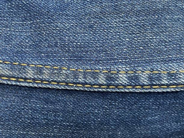 istock texture of blue denim jeans with seams. 1490546108