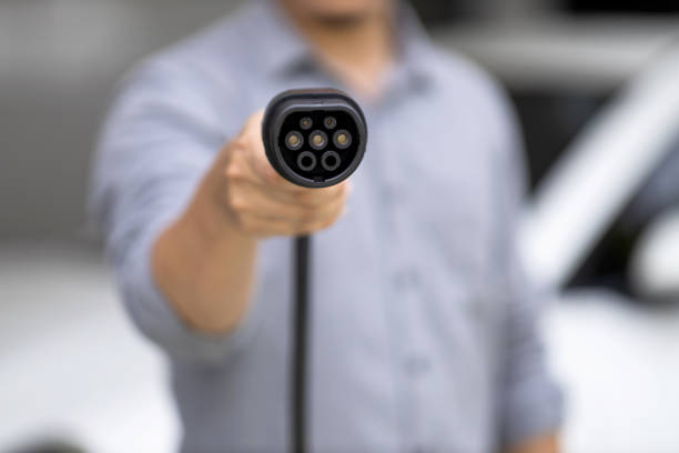 istock Focus progressive EV charger device pointing at camera with blur background. 1490549680