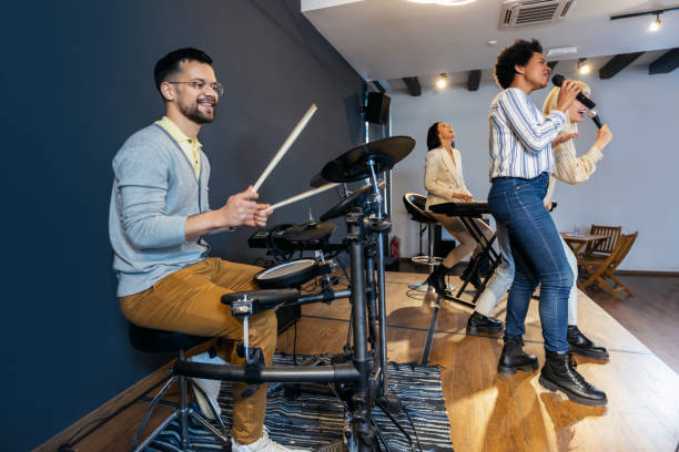 istock Business people making team training exercise during team building seminar singing karaoke. 1490549971