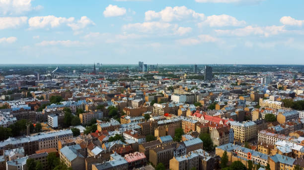 istock Riga Cityscape Spring Aerial Top View , Town, Latvia. Sunny Day Building Rooftops. Riga Skyline, Latvia, City Center, Teika, Purvciems in the Background. Architecture of the Downtown. 1490552111