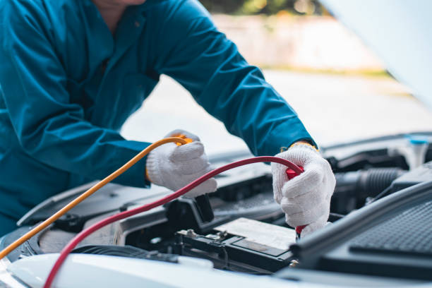 istock Battery charging. Terminals and hands. auto service. a gas station. 1490554713