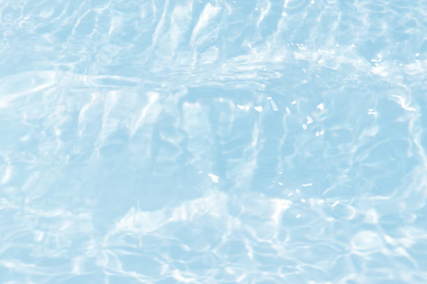 istock Blue water with ripples on the surface. Defocus blurred transparent blue colored clear calm water surface texture with splashes and bubbles. Water waves with shining pattern texture background. 1490555962