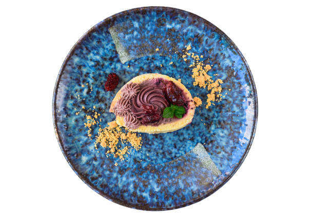 istock Mulberry Roll Cake on blue plate isolated on white background 1490559300