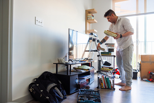 Unpacking and making a house a home by putting personal items in place.