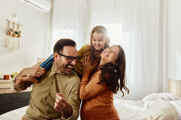 istock Young cheerful family having fun in bedroom. 1490563078