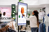 Woman buyer selecting clothes on board