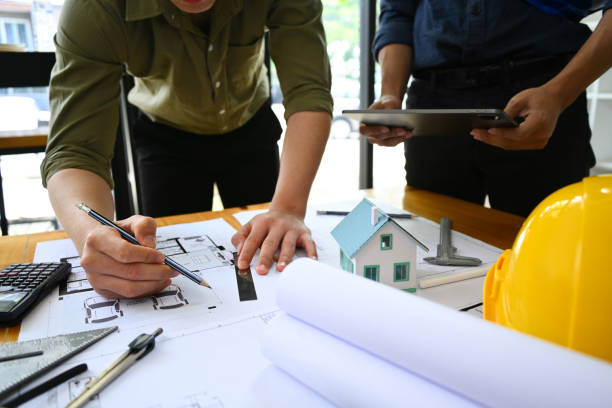istock Architects team collaborating, planning working together at co working space in office. 1490564864