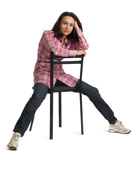 istock Woman sits on a chair back to front. 149056571