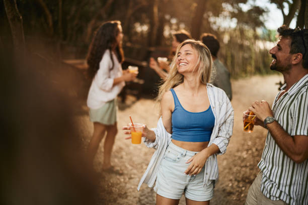 Cheerful couple dancing during spring party in nature.