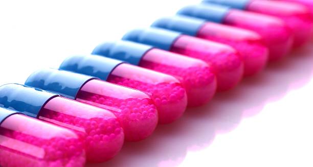 Row of blue and pink capsules stock photo