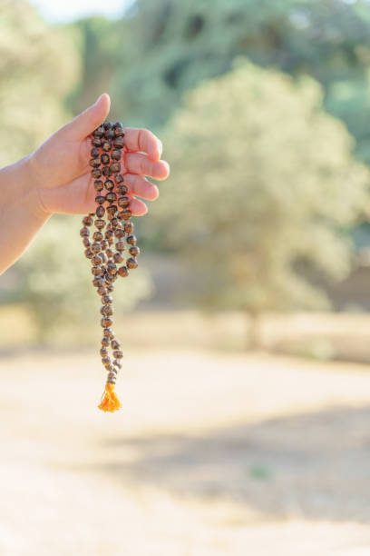 istock woman's hands holding a hindu japa mala in meditation 1490570629