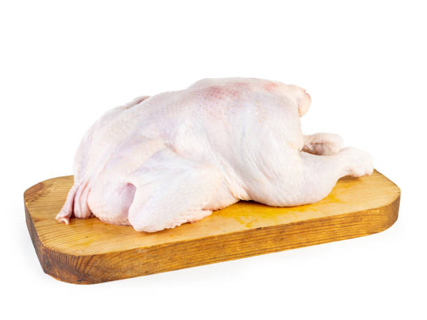 istock raw chicken carcass on a wooden board 1490570854