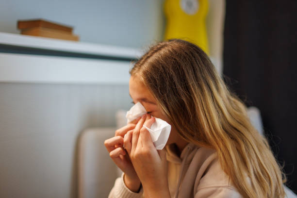 Teenage Girl Crying During Psychotherapy Teenage girl sits on a couch and cry while talks to the psychotherapist at his office. self mutilation pictures stock pictures, royalty-free photos & images