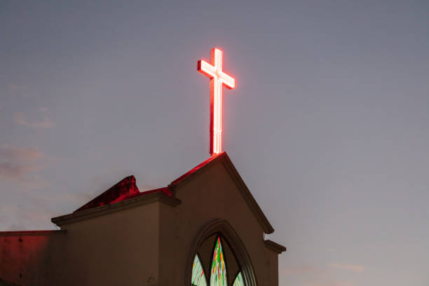 istock Illuminated cross on a church during blue hour. 1490576915