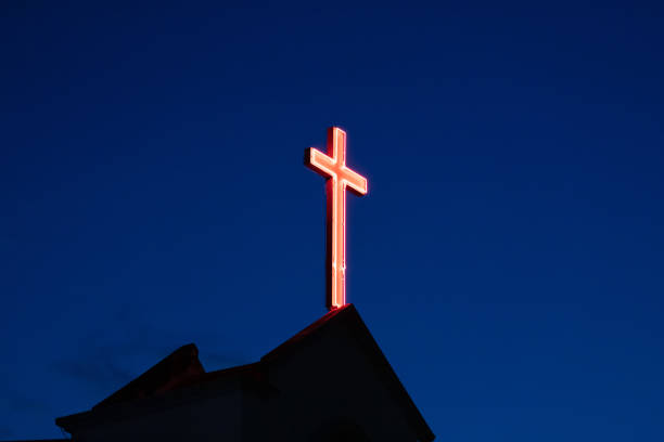 istock Illuminated cross on a church during blue hour. 1490576942