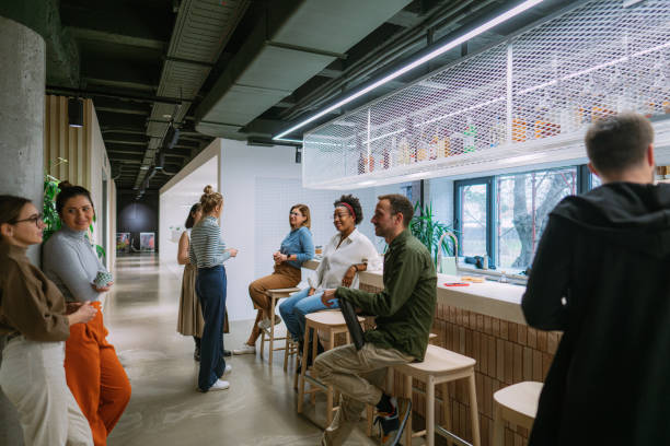 istock Colleagues taking a coffee break in the office cafeteria 1490576985