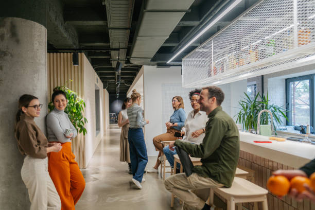 Colleagues taking a coffee break in the office cafeteria