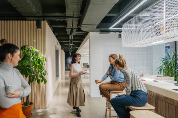 istock Colleagues taking a coffee break in the office cafeteria 1490577069
