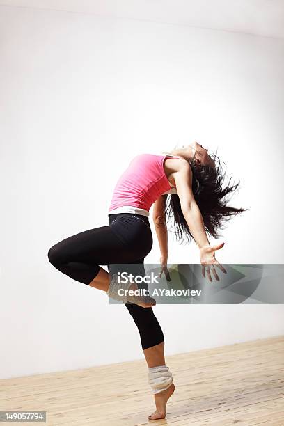 Women In Leg Warmers Bends Backwards While Dancing Stock Photo - Download Image Now - Jazz Dancing, Teenage Girls, Acrobat