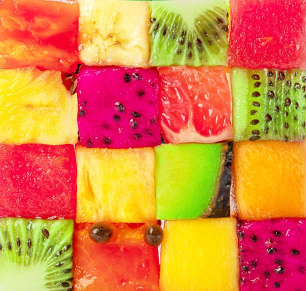 Fruit puzzle. Colorful food background or pattern arranged of different fruit cubes. Dietary concept. Fruit puzzle. Colorful food background or pattern arranged of different fruit cubes. Dietary concept. food fruit close up strawberry stock pictures, royalty-free photos & images