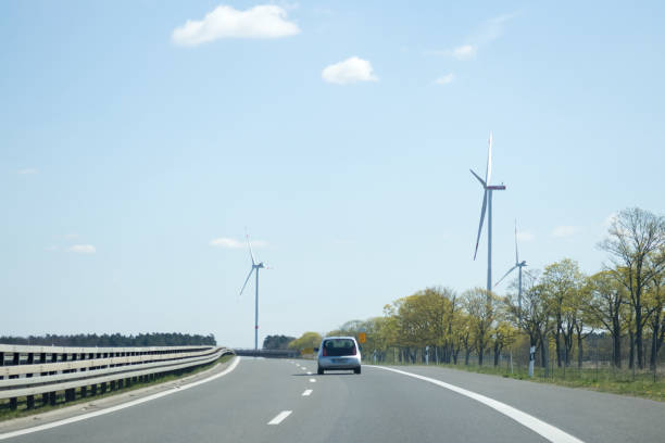 istock A car drives along a highway along which there are windmills 1490578737