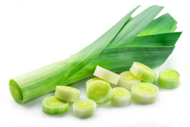 istock Fresh green leek stems and leek slices isolated on white background. 1490578792