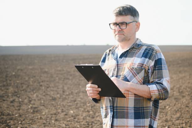 istock A farmer checks quality of soil before sowing. 1490581600