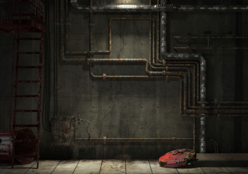 grunge interior room of an abandoned industrial warehouse showing a concrete wall with lots of pipes, stairs and a garbage can