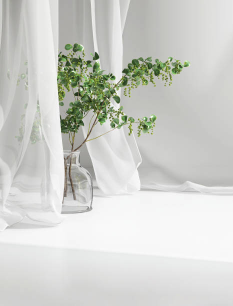 istock Empty white counter table, soft, smooth blowing sheer fabric curtain drapery, tree branch glass vase in sunlight 1490583754