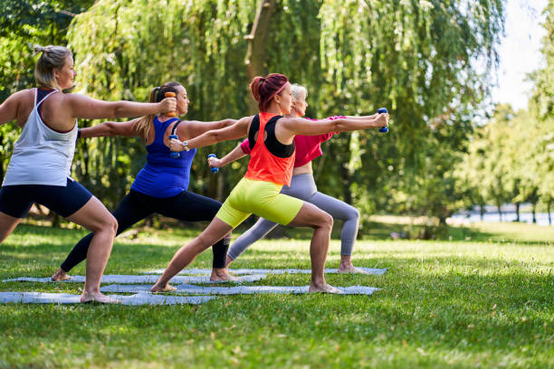 Group of women doing outdoor workout in park stock photo