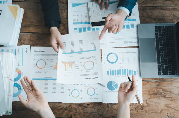 istock startup business, business advisor explaining strategy for planning finance investment teamwork paperwork audit and discussing marketing, profit, budget of company in meeting room. 1490586559