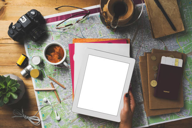 istock Travel concept flat lay, hand holding blank screen digital tablet 1490587143
