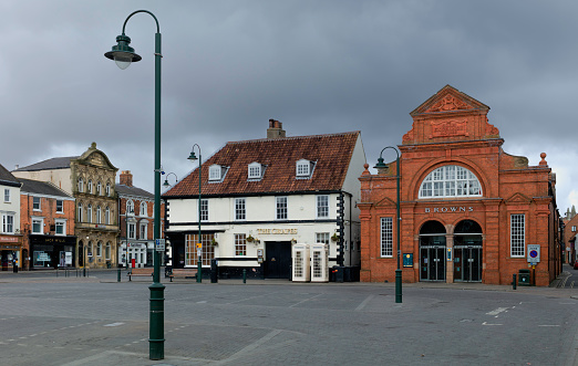 BEVERLEY, UK - 28 MARCH, 2020: Town centre showing prominent retail stores and public house and no people during pandemic lockdown on March 28, 2020 in Beverley, Yorkshire, UK.